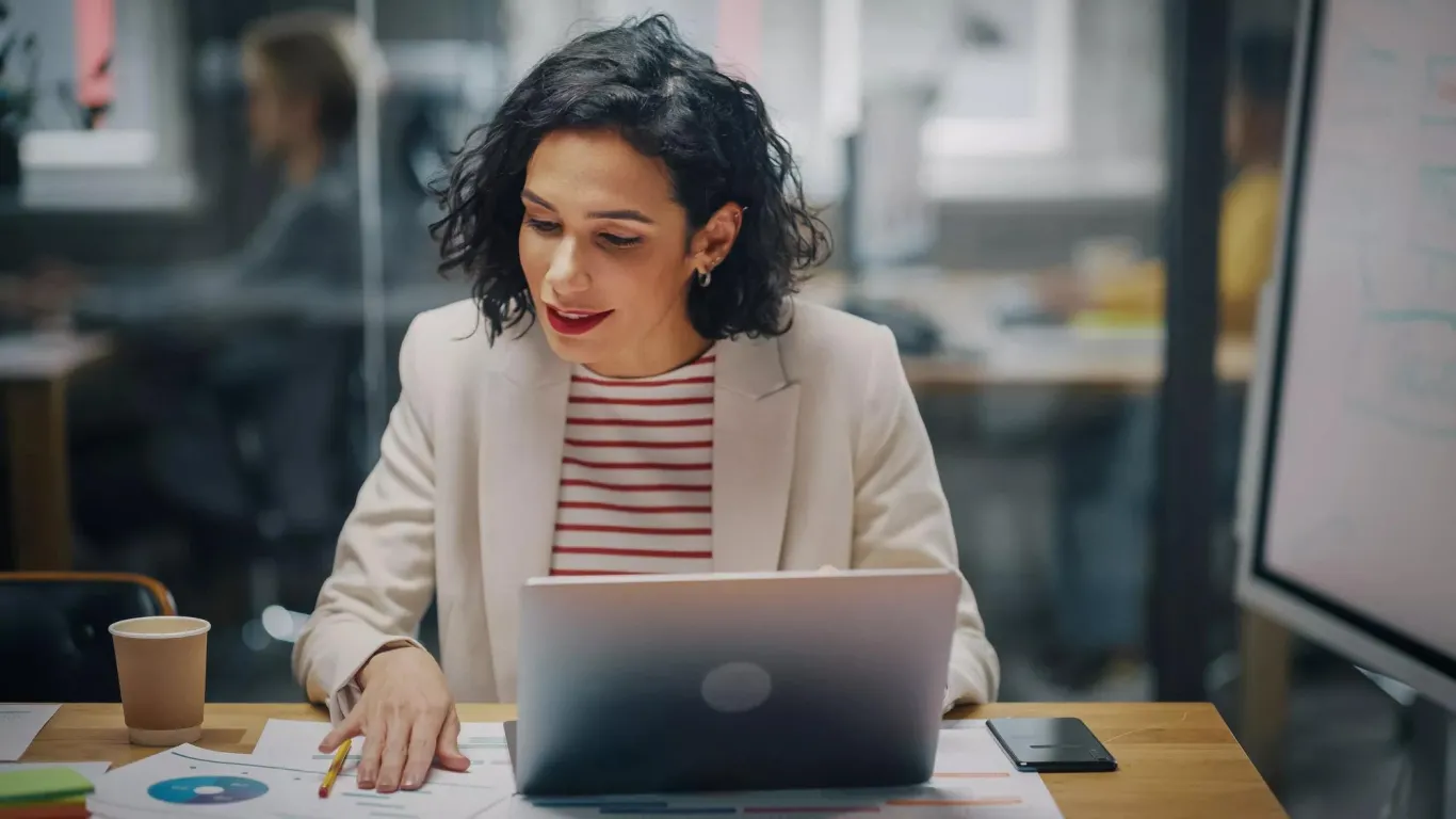 A woman reviewing her finances to consider hiring a TPA.