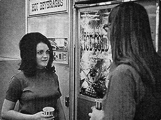 Bankers Life employees in front of a vending machine in the 1970s